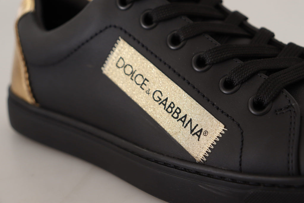 Dolce & Gabbana black leather low top sneakers for women with gold accents and sleek design.