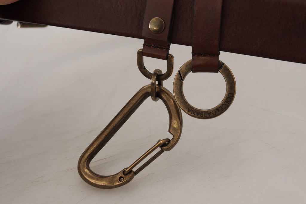 Dolce & Gabbana brown leather belt with gold metal buckle and carabiner detail on a white background.
