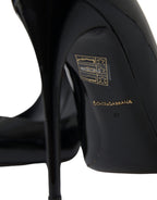 Dolce & Gabbana black patent leather pumps with pointed heels and sleek design, perfect for elegant formal occasions.
