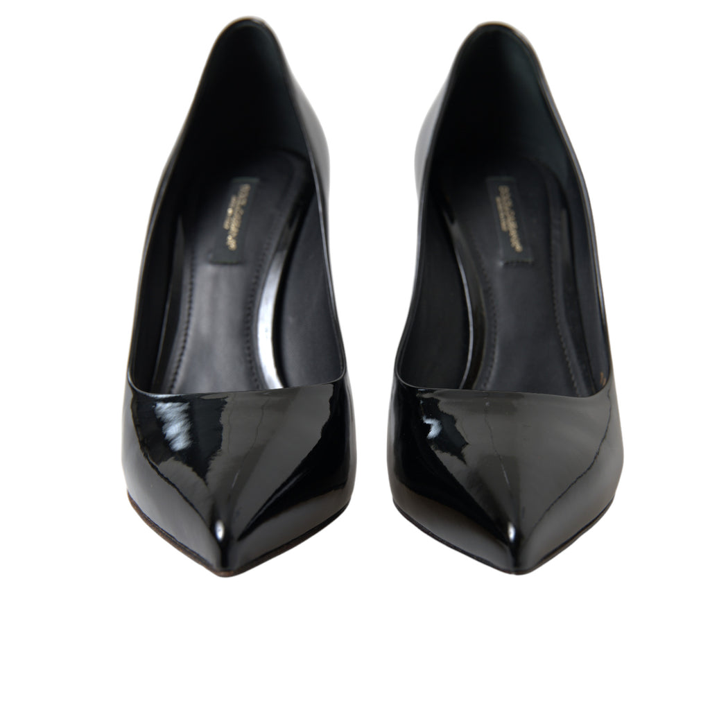 Black patent leather Dolce & Gabbana pumps with pointed toes and stiletto heels, stylish women's high-heeled shoes.