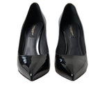 Black patent leather Dolce & Gabbana pumps with pointed toes and stiletto heels, stylish women's high-heeled shoes.