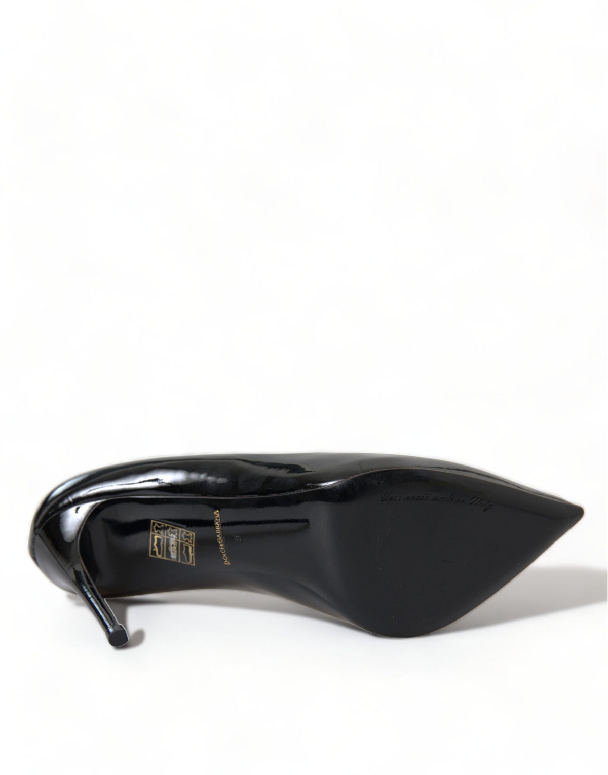 Black patent leather Dolce & Gabbana pumps with pointed toes and stiletto heels, stylish women's shoe fashion.