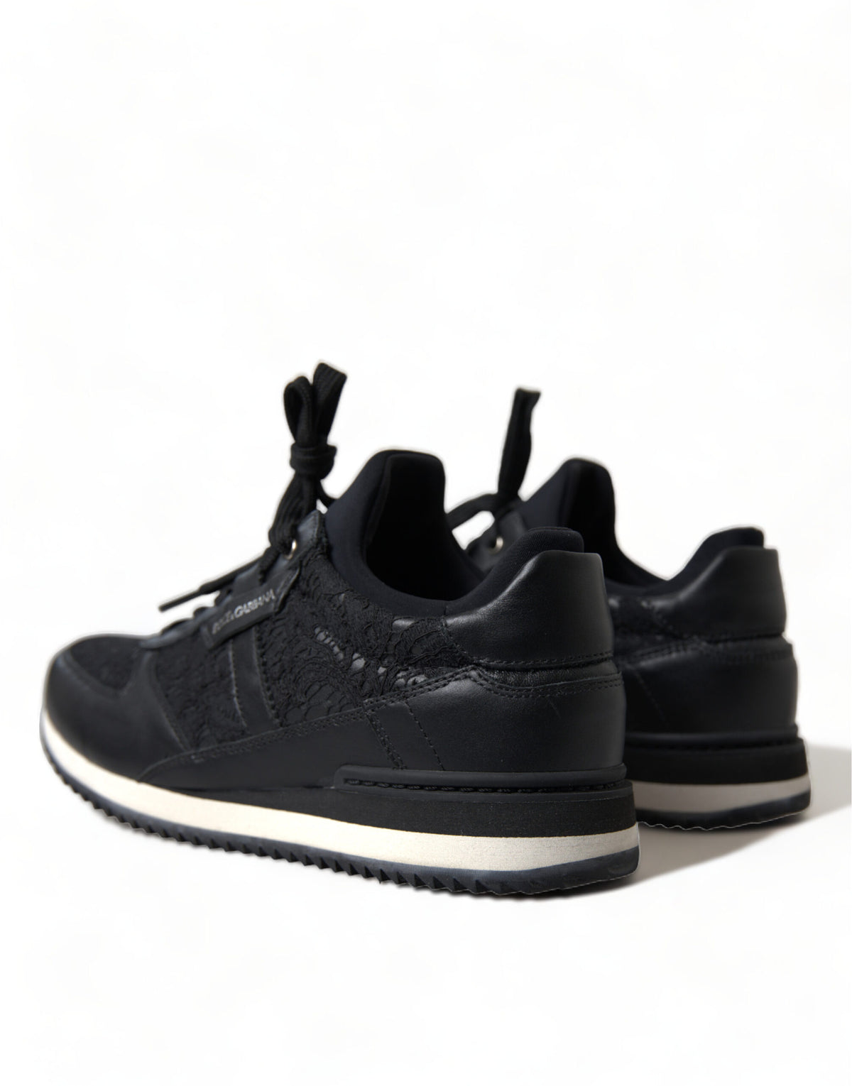 Dolce & Gabbana black floral lace leather sneakers showing detailed lace design and sleek sneaker silhouette.