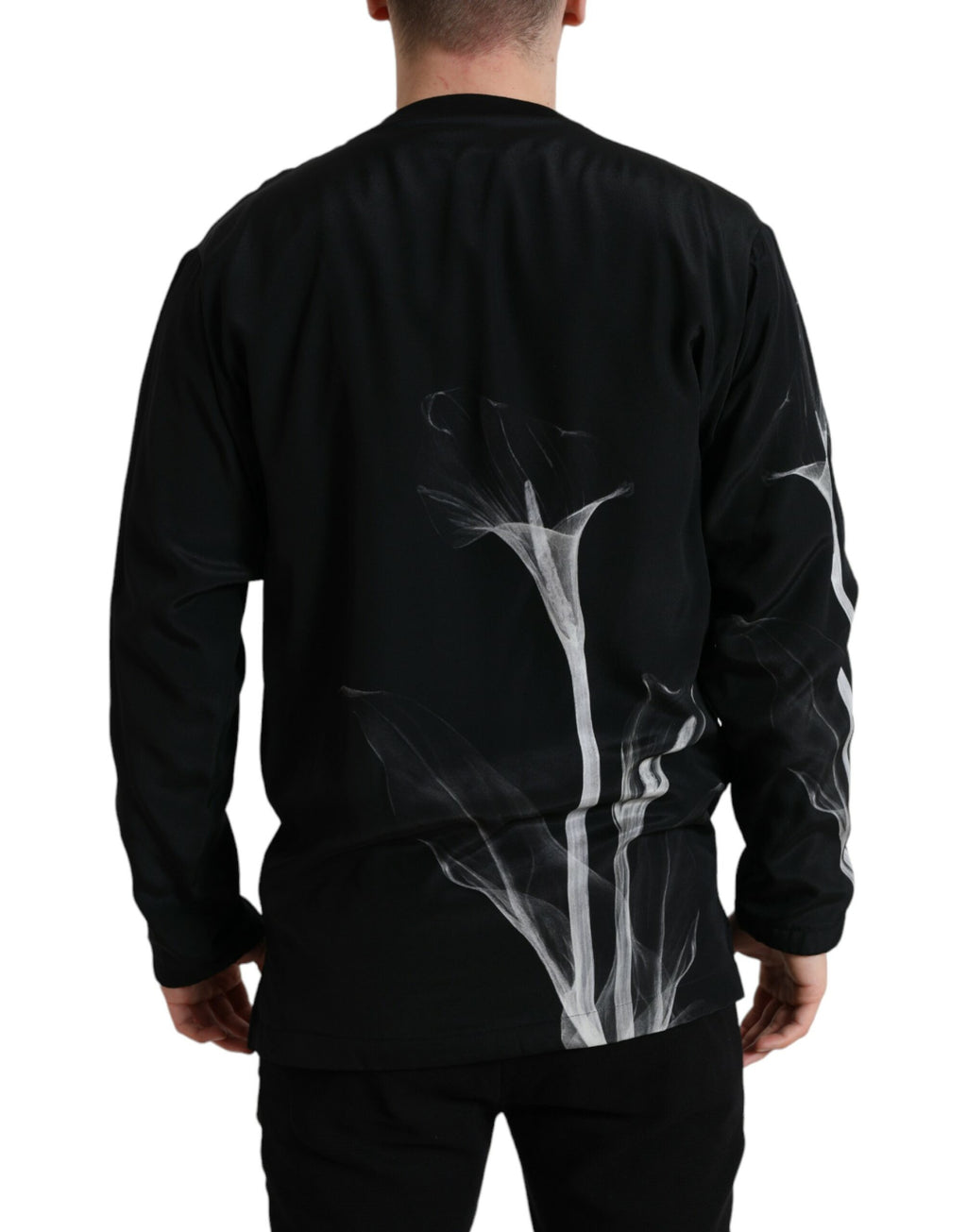 Dolce & Gabbana black floral print crewneck pullover sweater displayed on a hanger, showcasing its stylish design and fabric details.