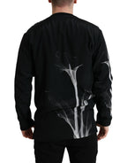 Dolce & Gabbana black floral print crewneck pullover sweater displayed on a hanger, showcasing its stylish design and fabric details.