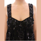 Dolce & Gabbana black floral crystal-embellished dress displayed on a hanger with intricate floral details and sparkling embellishments.