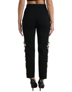 Dolce & Gabbana black floral applique high waist tapered pants with elegant floral details and tailored fit.