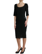 Dolce & Gabbana black floral lace viscose bodycon midi dress displayed on a hanger with intricate lace details.