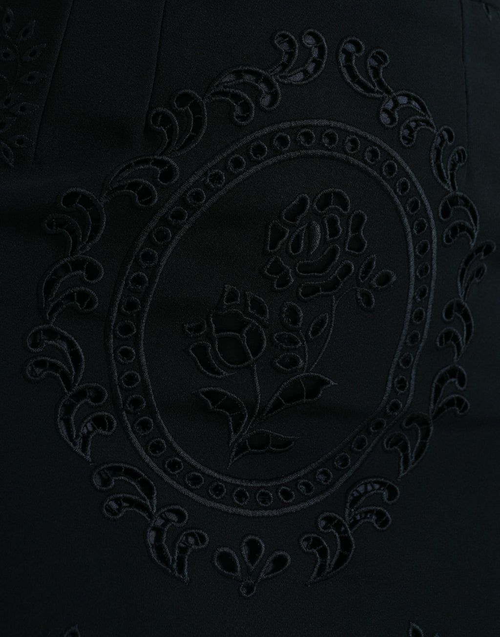 Dolce & Gabbana black floral lace viscose bodycon midi dress displayed on a hanger with intricate lace details.