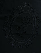 Dolce & Gabbana black floral lace viscose bodycon midi dress displayed on a hanger with intricate lace details.