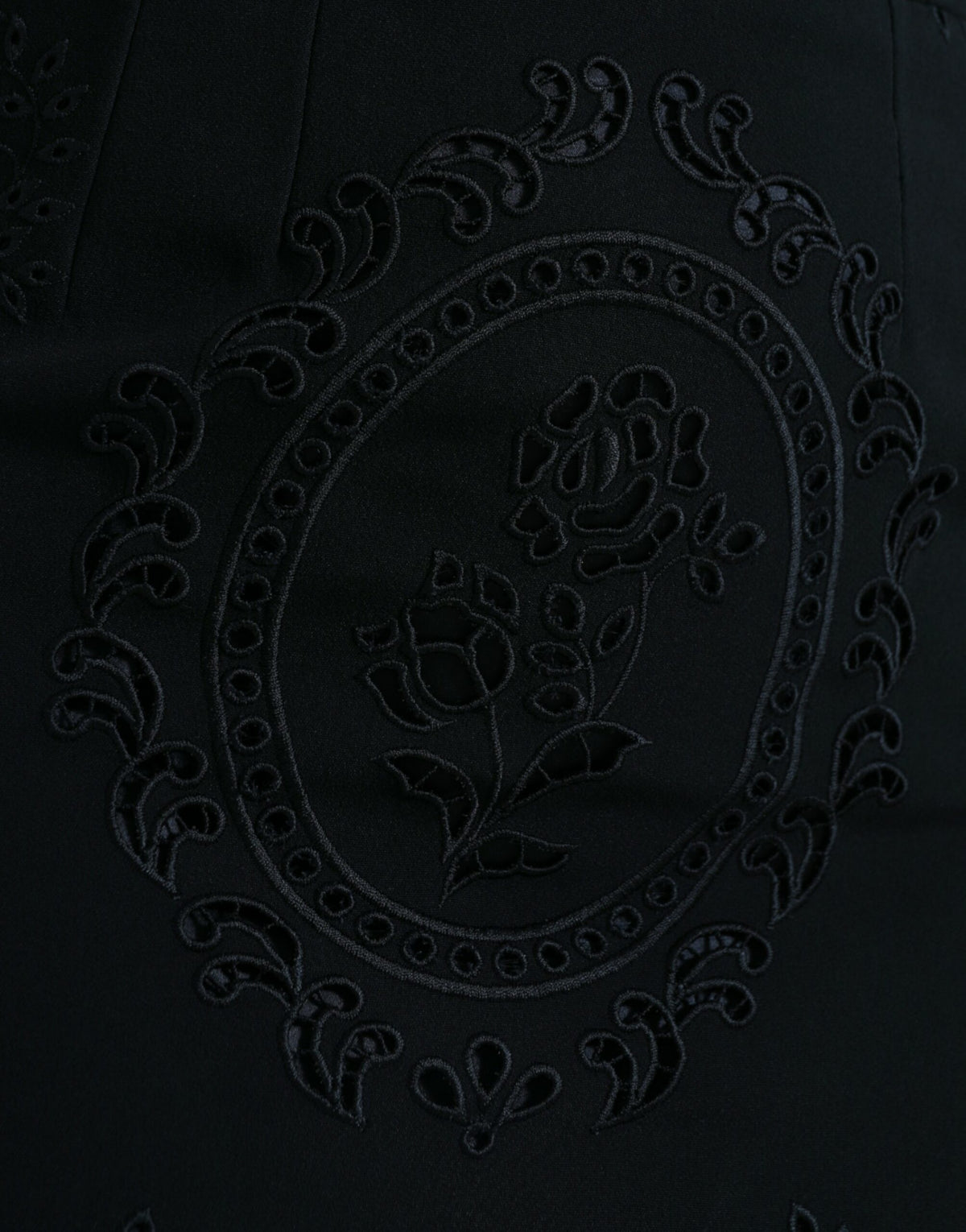 Dolce & Gabbana black floral lace viscose bodycon midi dress displayed on a hanger with intricate lace details.