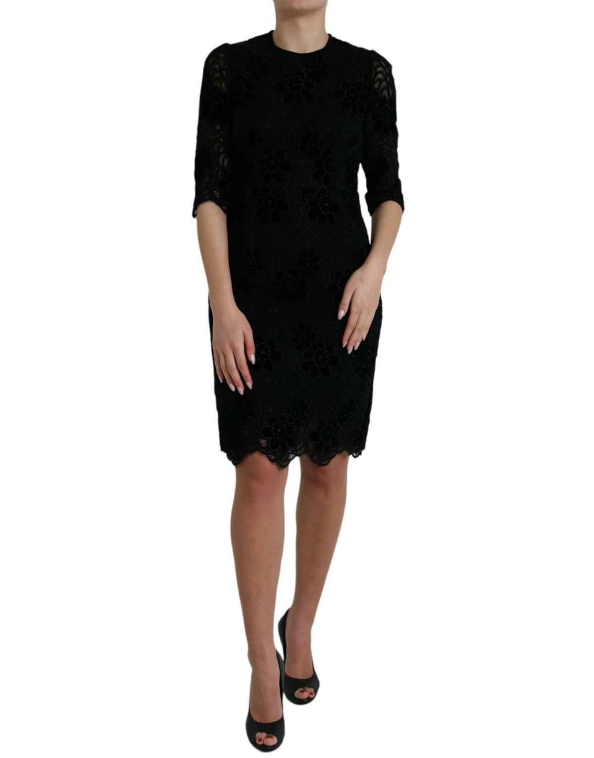Black floral lace cotton Dolce & Gabbana bodycon dress displayed on a hanger with intricate lace details and fitted silhouette.