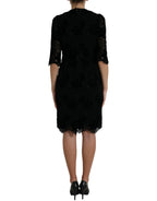 Black floral lace cotton bodycon dress by Dolce & Gabbana, featuring a fitted silhouette and intricate lace detailing.
