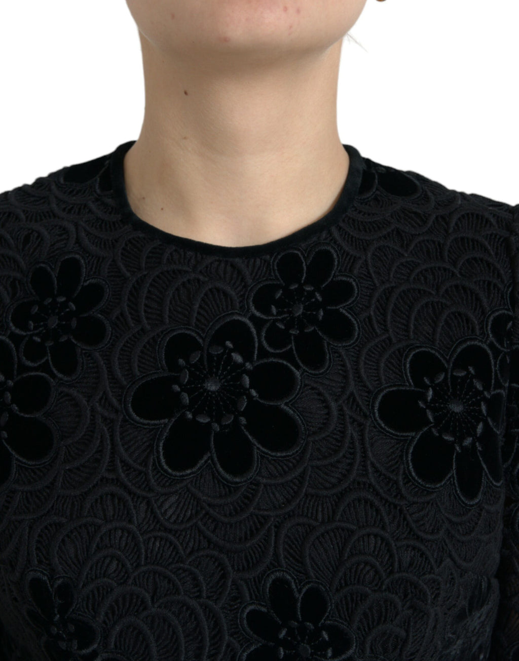 Dolce & Gabbana black floral lace cotton bodycon dress displayed on a hanger, showcasing intricate lace details and fitted silhouette.