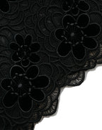 Black floral lace cotton bodycon dress by Dolce & Gabbana displayed on a hanger, showcasing intricate lace details and fitted silhouette.