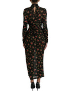 Dolce & Gabbana black floral cut-out sheath long maxi dress displayed on a hanger. Elegant evening wear with floral details and cut-out design.
