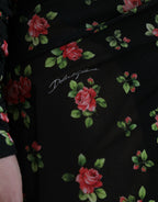 Dolce & Gabbana black floral cut-out sheath long maxi dress displayed on a hanger with intricate floral details and elegant design.