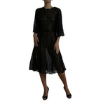 Dolce & Gabbana black floral lace sheer A-line midi dress displayed on a mannequin with intricate lace details.