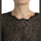 Dolce & Gabbana black floral lace sheer A-line midi dress displayed on a hanger with intricate lace details.