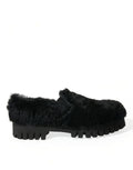 Black leather slippers with plush fur trim by Dolce & Gabbana, designed as elegant dress shoes with sleek, stylish detailing.