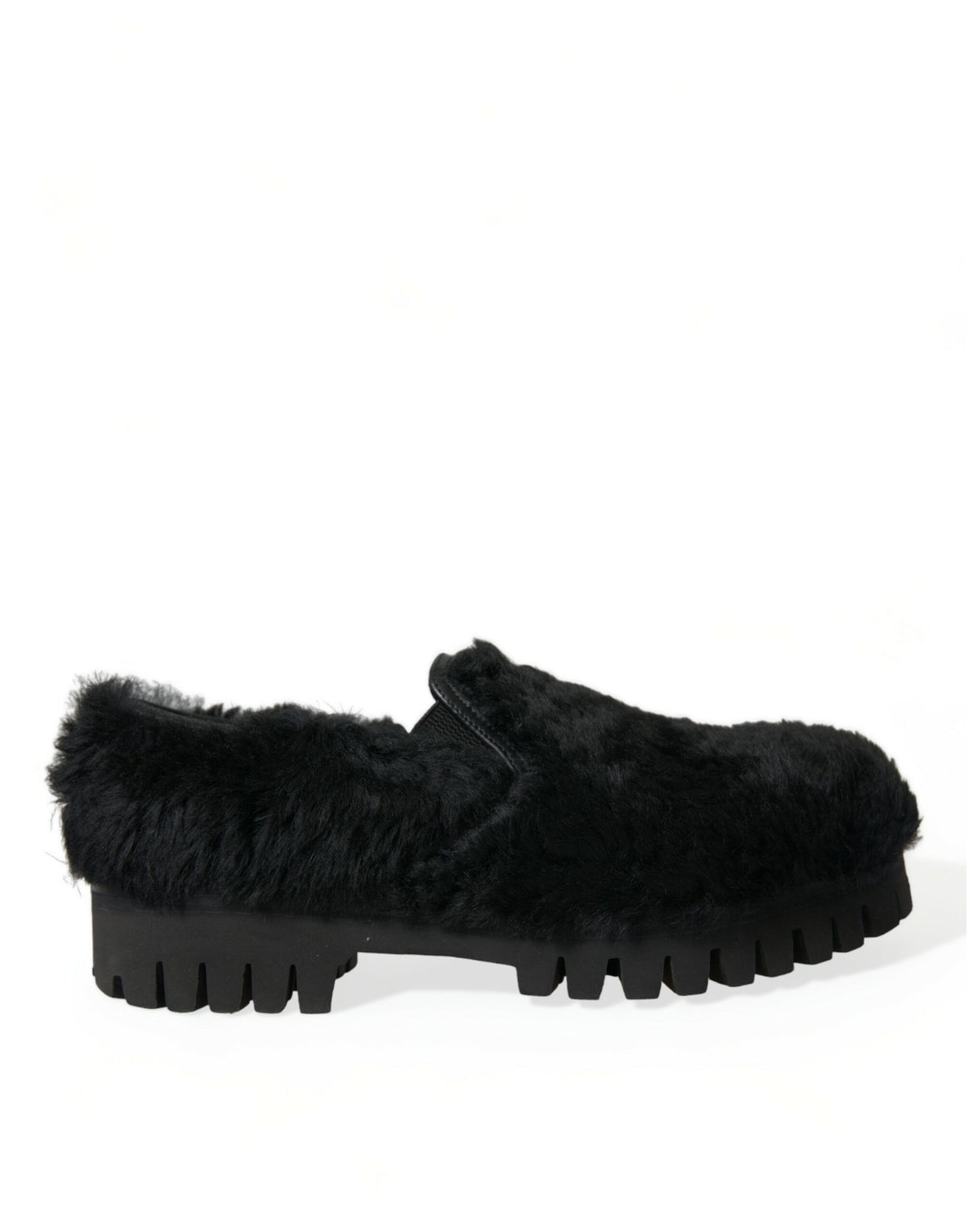 Black leather slippers with plush fur trim by Dolce & Gabbana, designed as elegant dress shoes with sleek, stylish detailing.