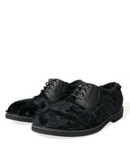 Black leather lace-up derby dress shoes with fur accents by Dolce & Gabbana, featuring a polished finish and classic design.