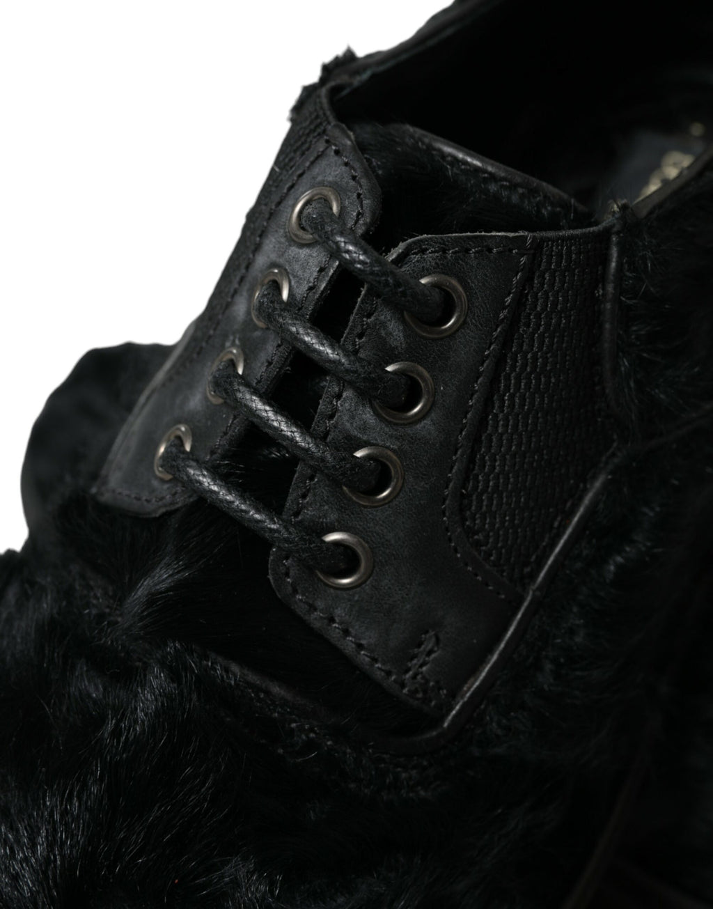 Black leather lace-up derby dress shoes with fur accents by Dolce & Gabbana, featuring a classic design and polished finish.