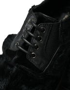 Black leather lace-up derby dress shoes with fur accents by Dolce & Gabbana, featuring a classic design and polished finish.