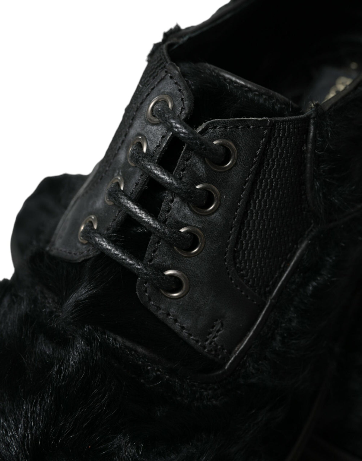 Black leather lace-up derby dress shoes with fur accents by Dolce & Gabbana, featuring a classic design and polished finish.