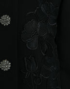 Dolce & Gabbana black floral wool jacket with button embellishments, featuring a stylish and elegant design.