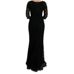 Elegant black Dolce & Gabbana floral Ricamo sheath long dress displayed on a model with detailed embroidery and flowing fabric.