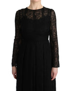 Dolce & Gabbana black floral lace sheath silk dress displayed on a hanger with intricate lace detailing and a fitted silhouette.