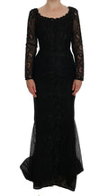 Dolce & Gabbana black floral sheath dress displayed on a hanger, showcasing elegant floral pattern and fitted silhouette.