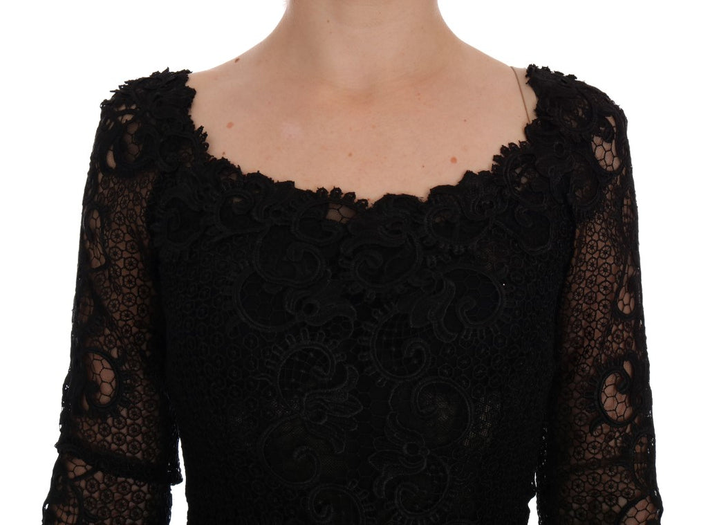Dolce & Gabbana black floral sheath dress displayed on a mannequin, showcasing elegant design and vibrant floral pattern.