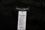 Dolce & Gabbana black floral sheath dress displayed on a hanger with detailed floral pattern and fitted silhouette.