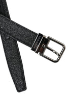 Dolce & Gabbana black leather belt with glitter finish and silver buckle, stylish accessory with bold design.
