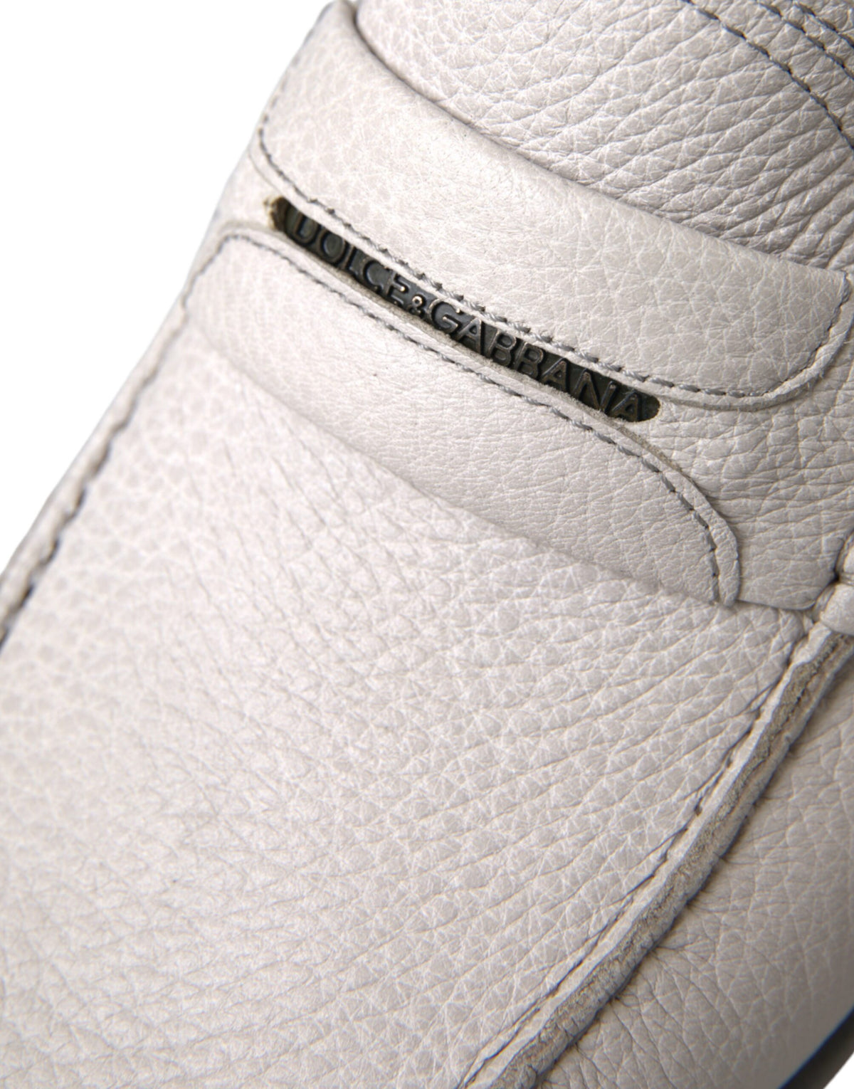 Dolce & Gabbana white and gray leather slip-on mocassin shoes with loafers design on a plain background.
