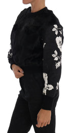 Dolce & Gabbana black fur floral brocade zipper sweater displayed on a hanger showing detailed floral embroidery and fur accents.