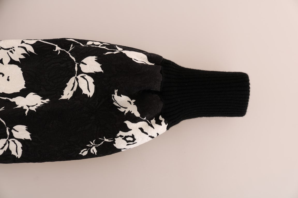 Dolce & Gabbana black fur floral brocade zipper sweater displayed on a hanger with intricate floral patterns and luxurious fabric.
