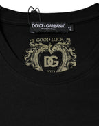 Black cotton Dolce & Gabbana crew neck short sleeve T-shirt displayed on a hanger with a simple background.