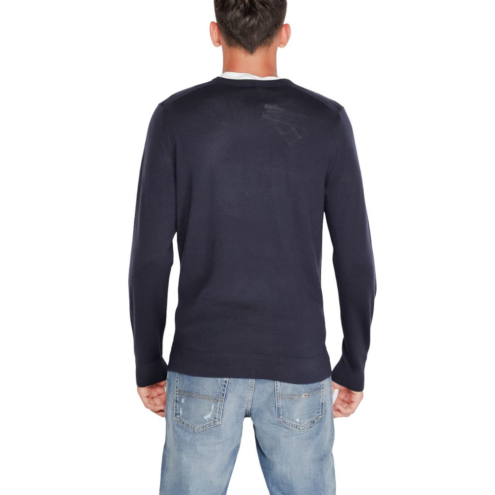 Calvin Klein blue recycled wool sweatshirt with ribbed cuffs and neckline, casual fit, displayed on a plain background.