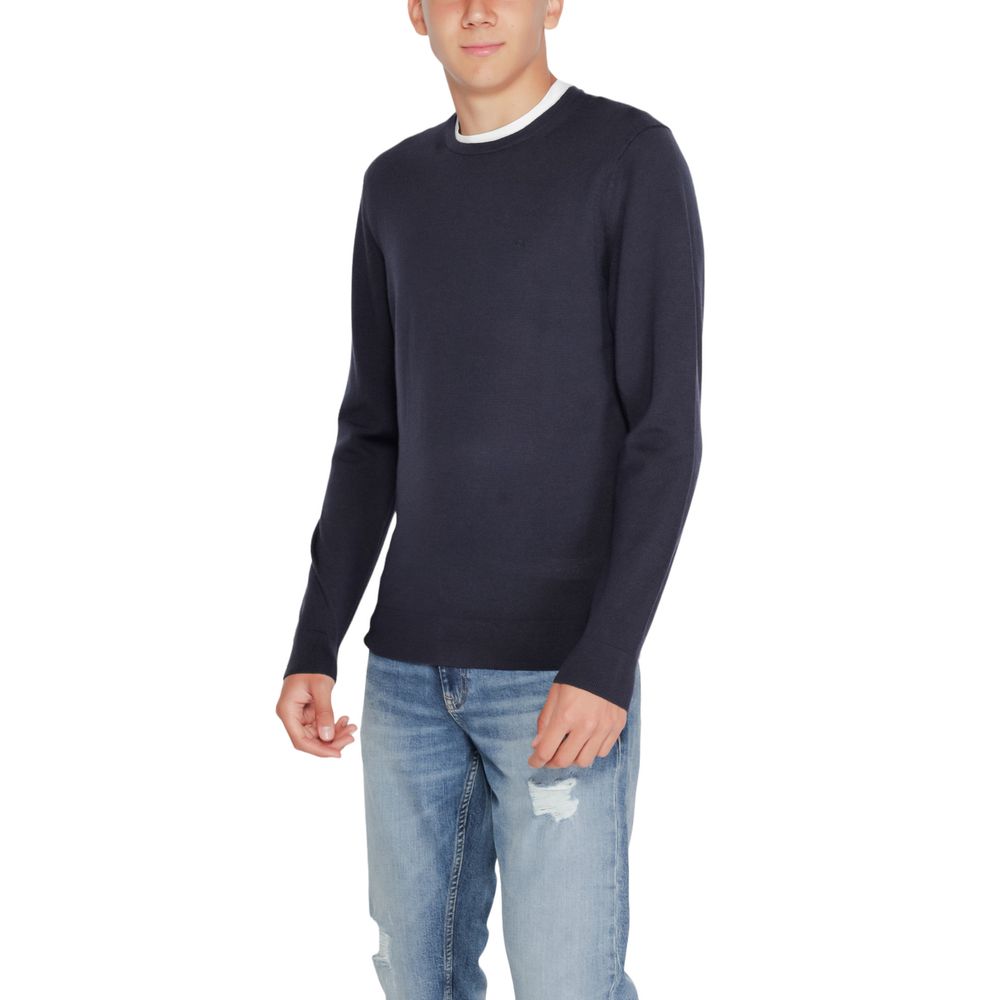 Calvin Klein blue recycled wool sweatshirt featuring a crew neck and long sleeves, displayed on a neutral background.