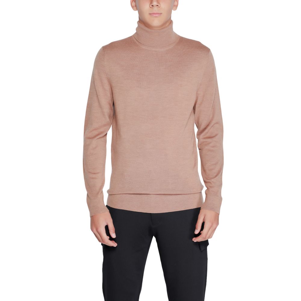Calvin Klein beige wool turtleneck sweater displayed on a mannequin, showcasing its soft fabric and classic fit.
