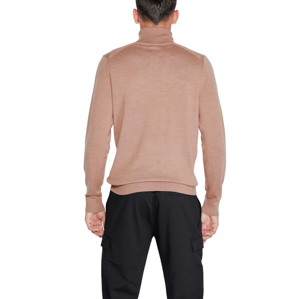Beige wool turtleneck sweater by Calvin Klein, shown on a hanger with a close-up of the knit fabric and turtleneck collar.