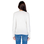 White cotton sweatshirt by Guess with a crew neckline and relaxed fit, displayed on a hanger.