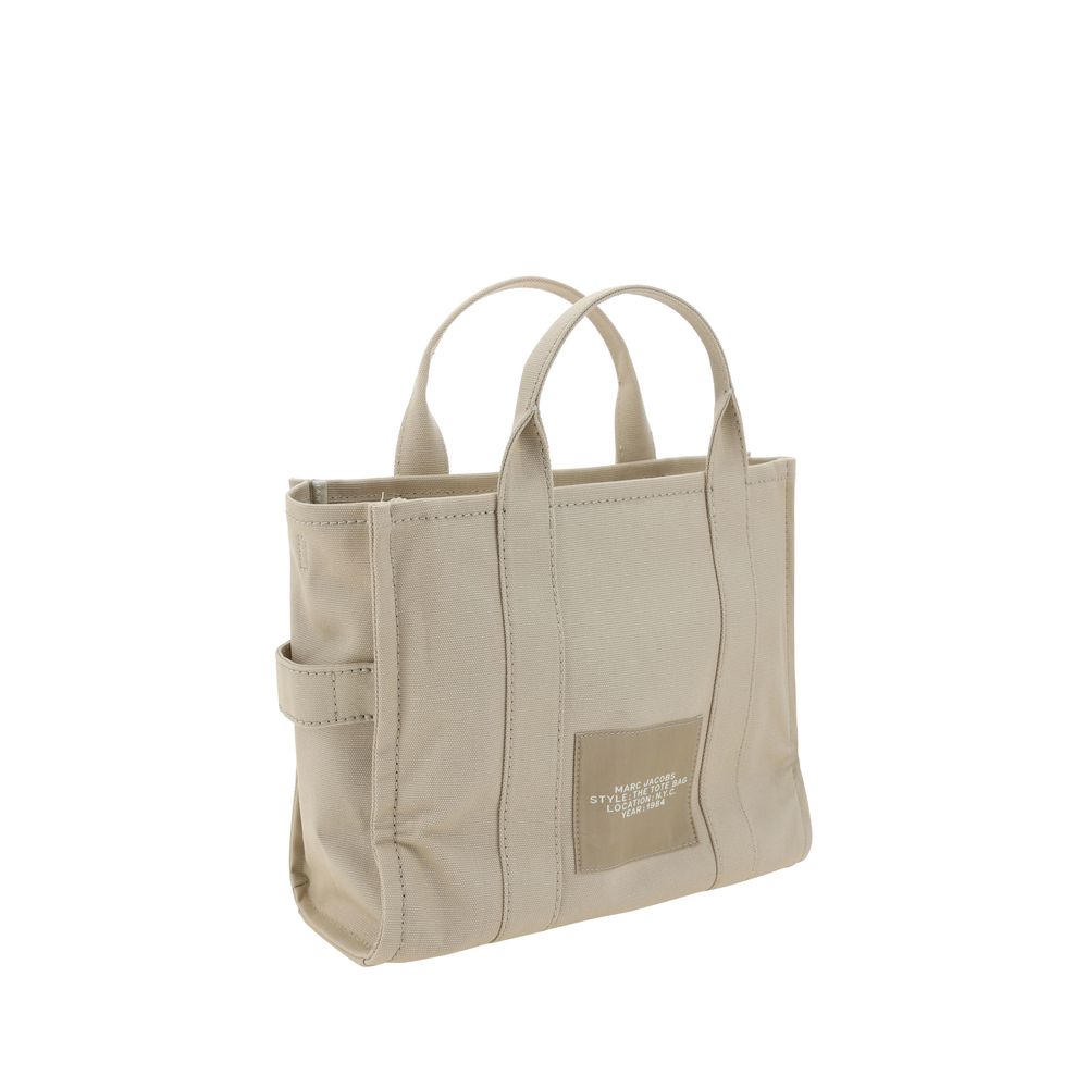 Beige cotton Marc Jacobs handbag with top handles and minimalist design, featuring subtle branding and clean stitching details.