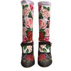 Dolce & Gabbana black floral socks paired with crystal-embellished jersey shoes, featuring stylish and intricate design details.