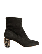 Black embellished heel ankle boots by Dolce & Gabbana with pointed toes and decorative detailing.