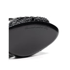 Dolce & Gabbana black snake skin platform sandals with ankle straps and chunky heels.
