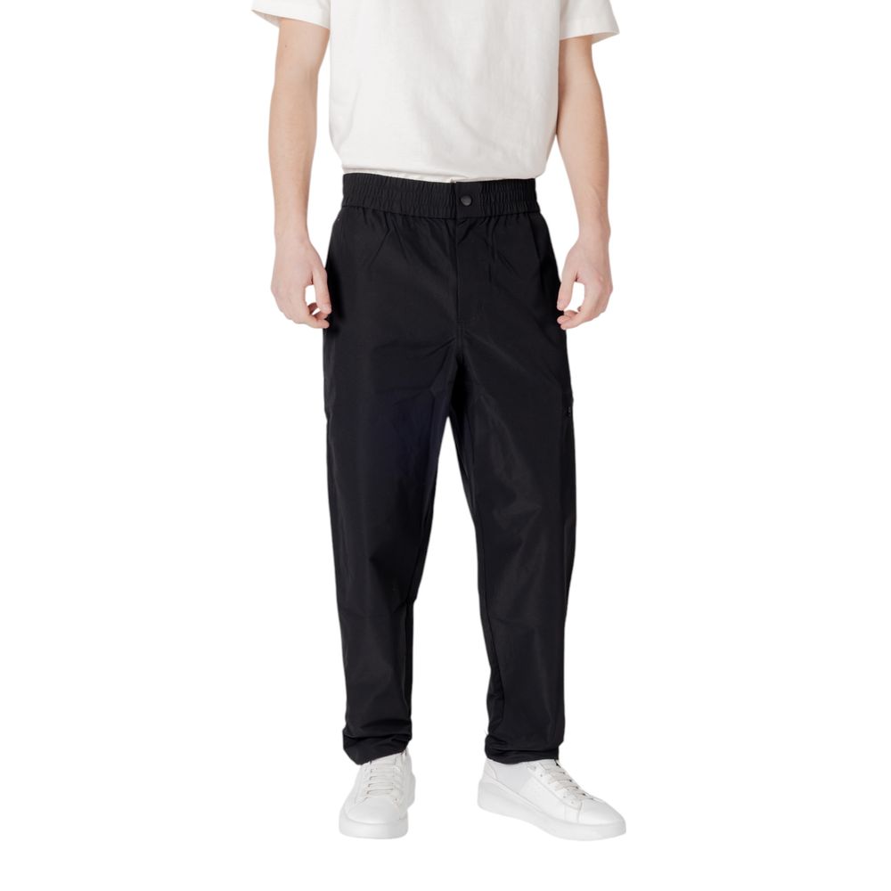 Calvin Klein Jeans black polyester casual pants with a relaxed fit, featuring a modern design and classic waistband.